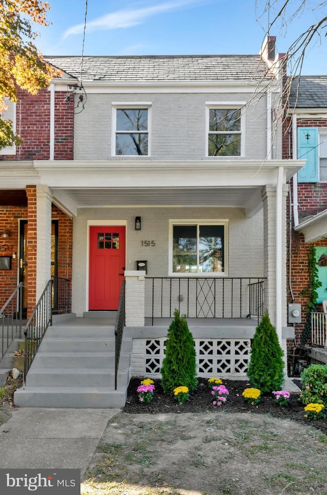 1515 Montana Ave NE, Washington, DC 20018 - view of property featuring brick siding, a porch, and a high end roof