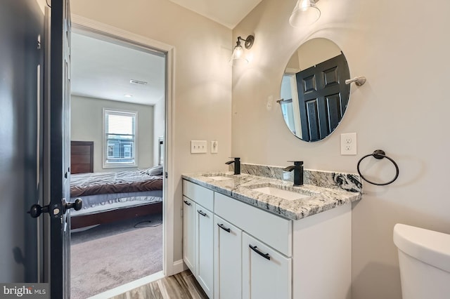 3540 Keswick Rd, Baltimore, MD 21211 - ensuite bathroom featuring wood finished floors, double vanity, and toilet