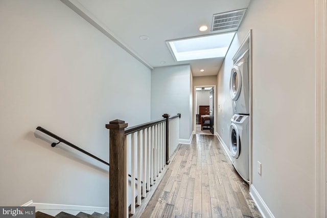 3540 Keswick Rd, Baltimore, MD 21211 - laundry room with stacked washer / drying machine, light wood-style flooring, baseboards, and recessed lighting