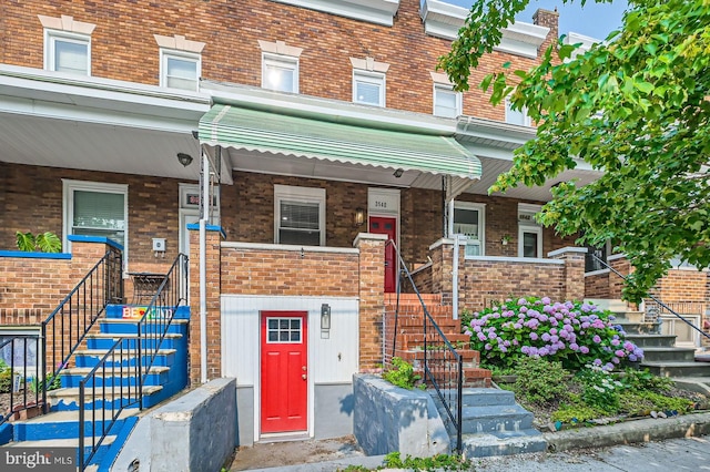 3540 Keswick Rd, Baltimore, MD 21211 - view of front of house featuring stairs, covered porch, and brick siding
