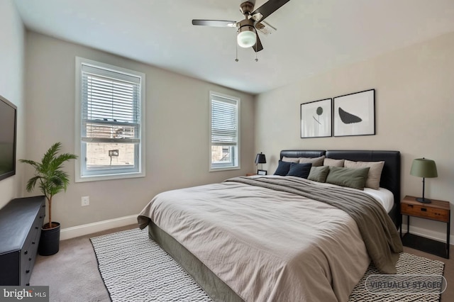 3540 Keswick Rd, Baltimore, MD 21211 - bedroom with multiple windows, light carpet, baseboards, and a ceiling fan