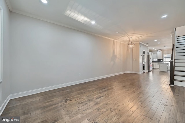 3540 Keswick Rd, Baltimore, MD 21211 - unfurnished living room with crown molding, recessed lighting, dark wood-style floors, baseboards, and stairway