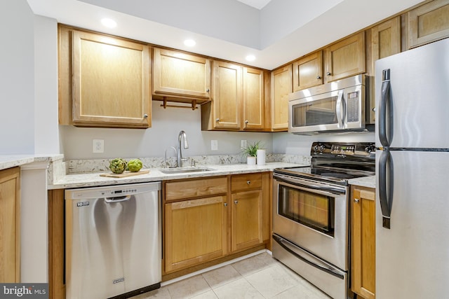 1001 N Randolph St Unit 513, Arlington, VA 22201 - kitchen featuring appliances with stainless steel finishes, a sink, light tile patterned flooring, light stone counters, and recessed lighting
