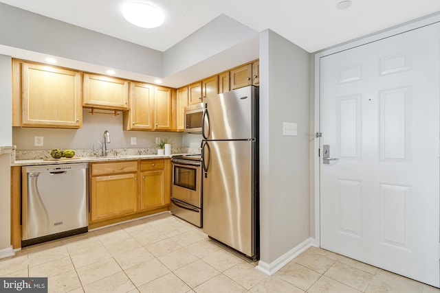 1001 N Randolph St Unit 513, Arlington, VA 22201 - kitchen with appliances with stainless steel finishes, a sink, light tile patterned floors, light brown cabinets, and baseboards