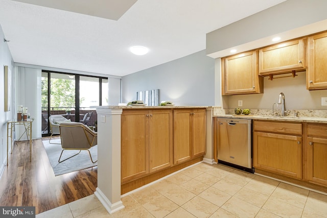 1001 N Randolph St Unit 513, Arlington, VA 22201 - kitchen with dishwasher, a sink, a peninsula, expansive windows, and light tile patterned floors
