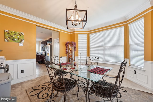 7306 Sudley Ave, Brandywine, MD 20613 - dining room with a decorative wall, wainscoting, a chandelier, plenty of natural light, and light carpet