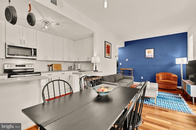 2630 Adams Mill Rd NW Unit 306, Washington, DC 20009 - dining space with light wood-style floors