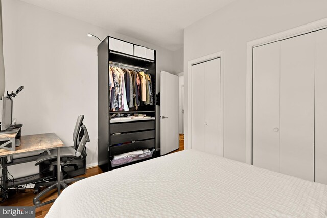2630 Adams Mill Rd NW Unit 306, Washington, DC 20009 - bedroom featuring a desk, multiple closets, and wood finished floors