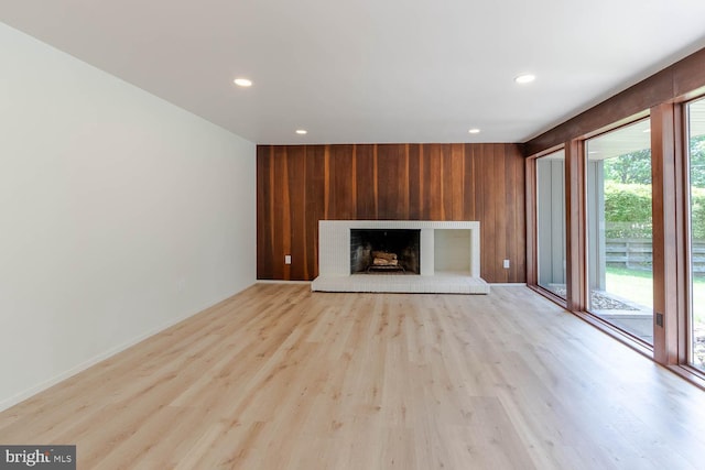 555 Hillcrest Ave, State College, PA 16803 - unfurnished living room with wood walls, recessed lighting, wood finished floors, a fireplace, and baseboards