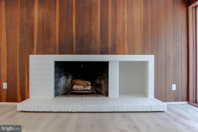 555 Hillcrest Ave, State College, PA 16803 - detailed view of a fireplace, wood walls, wood finished floors, and baseboards