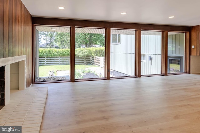 555 Hillcrest Ave, State College, PA 16803 - unfurnished living room featuring wood finished floors, wood walls, recessed lighting, and a fireplace