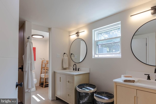 555 Hillcrest Ave, State College, PA 16803 - bathroom with two vanities, toilet, and tile patterned flooring