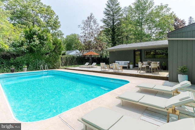 555 Hillcrest Ave, State College, PA 16803 - outdoor pool featuring an outdoor hangout area, a deck, a patio area, and view of scattered trees