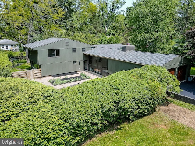 555 Hillcrest Ave, State College, PA 16803 - back of property featuring a chimney, a sunroom, and roof with shingles