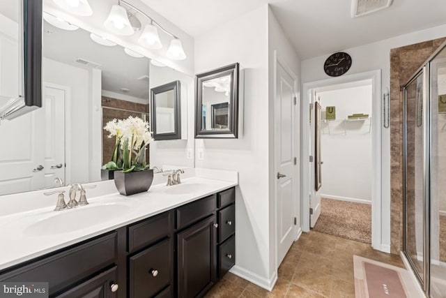 14302 Hidden Forest Dr, Accokeek, MD 20607 - full bathroom with a shower stall, double vanity, a walk in closet, baseboards, and tile patterned flooring