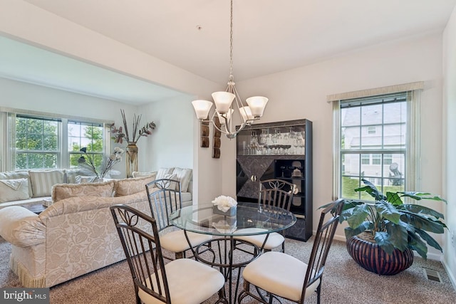14302 Hidden Forest Dr, Accokeek, MD 20607 - carpeted dining area with healthy amount of natural light, a chandelier, and baseboards