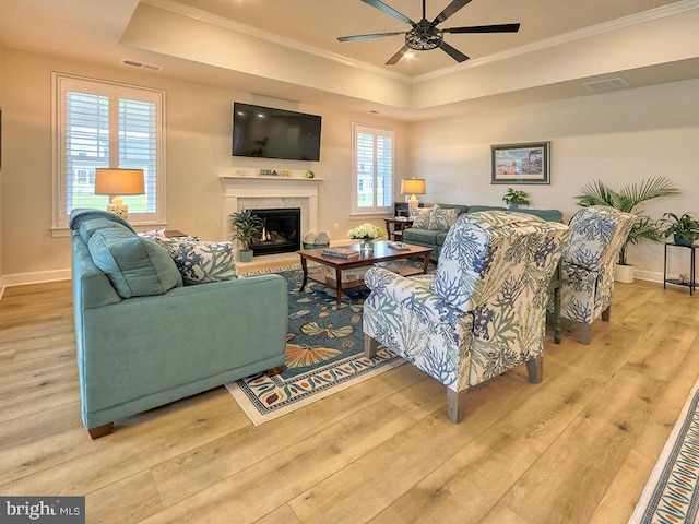 33016 Ethan Allen Dr, Rehoboth Beach, DE 19971 - living room with a tray ceiling, ceiling fan, wood finished floors, baseboards, and crown molding