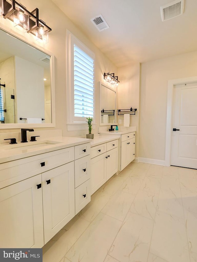 33016 Ethan Allen Dr, Rehoboth Beach, DE 19971 - bathroom featuring two vanities, marble finish floors, a shower with shower door, and baseboards