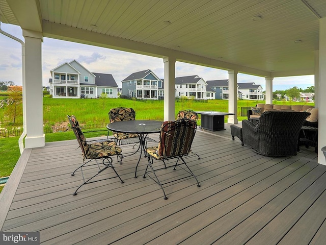 33016 Ethan Allen Dr, Rehoboth Beach, DE 19971 - wooden deck featuring outdoor dining area, a yard, a residential view, and outdoor lounge area