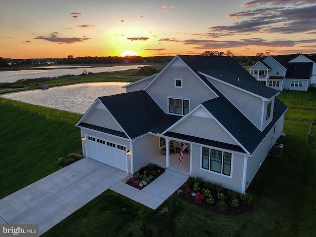 33016 Ethan Allen Dr, Rehoboth Beach, DE 19971 - traditional home with a porch, driveway, a yard, a garage, and a water view