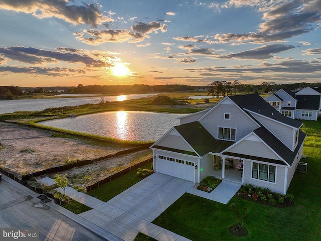33016 Ethan Allen Dr, Rehoboth Beach, DE 19971 - view of front of property with a water view, driveway, a yard, a garage, and covered porch