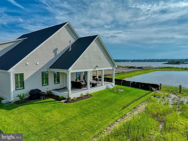 33016 Ethan Allen Dr, Rehoboth Beach, DE 19971 - rear view of house with a water view, an outdoor living space, a yard, and a shingled roof
