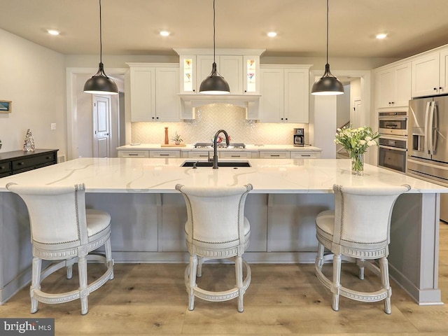 33016 Ethan Allen Dr, Rehoboth Beach, DE 19971 - kitchen featuring appliances with stainless steel finishes, white cabinetry, tasteful backsplash, and recessed lighting