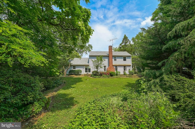 2640 Breezewood Dr, Lancaster, PA 17601 - back of house with a chimney and a lawn