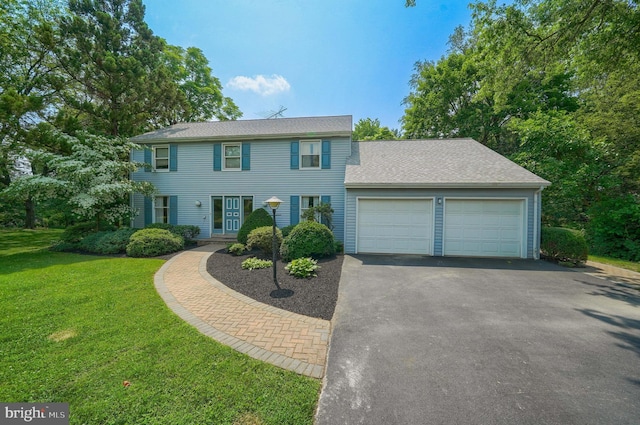 2640 Breezewood Dr, Lancaster, PA 17601 - colonial-style house featuring asphalt driveway, a garage, and a front yard