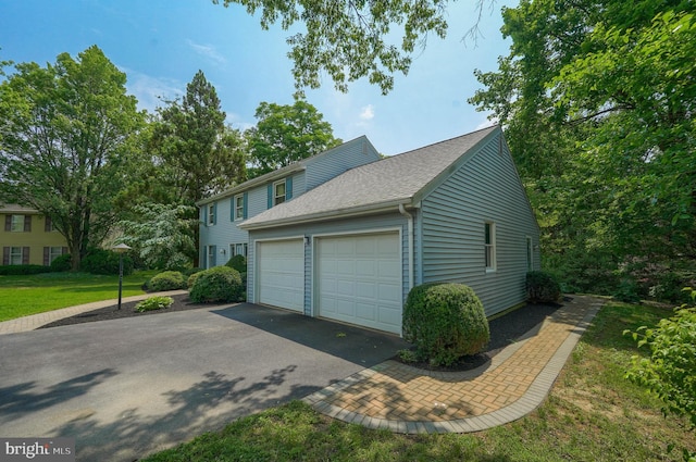 2640 Breezewood Dr, Lancaster, PA 17601 - view of property exterior with a garage, driveway, and roof with shingles