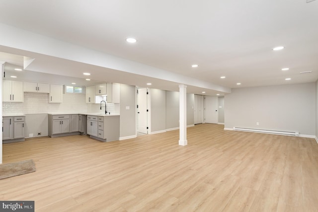 434 Bunker Hill Rd, Halifax, PA 17032 - unfurnished living room with a baseboard heating unit, a sink, light wood-style floors, recessed lighting, and baseboards