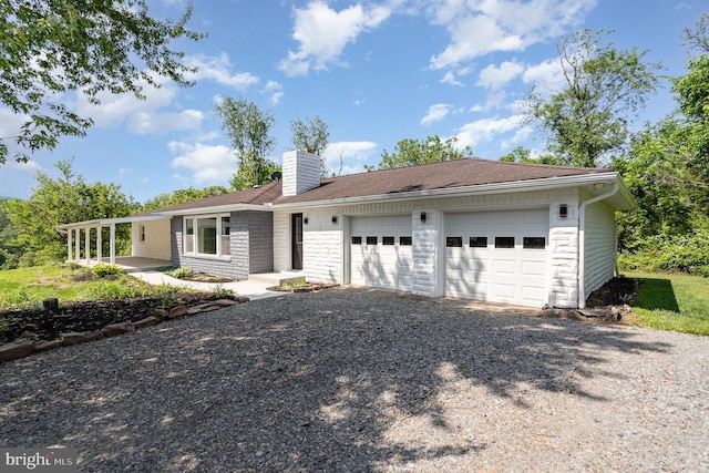 434 Bunker Hill Rd, Halifax, PA 17032 - view of front of house featuring a chimney, a garage, and gravel driveway