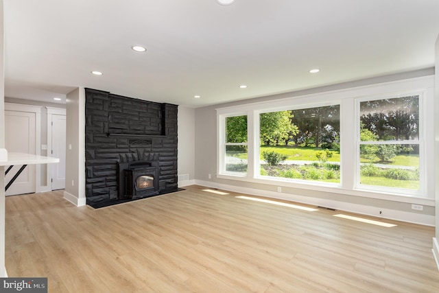 434 Bunker Hill Rd, Halifax, PA 17032 - unfurnished living room with baseboards, light wood-type flooring, recessed lighting, and a stone fireplace