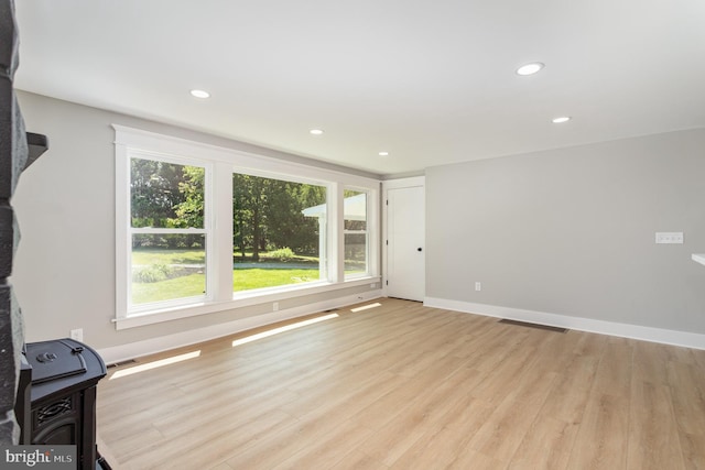 434 Bunker Hill Rd, Halifax, PA 17032 - unfurnished living room featuring plenty of natural light, light wood-style flooring, recessed lighting, baseboards, and a wood stove