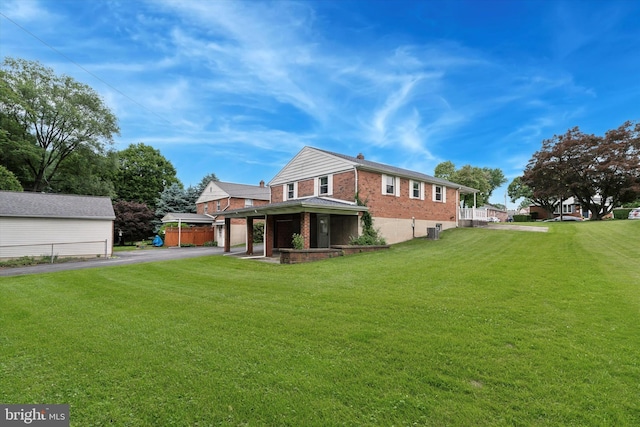 909 Rocklynn Rd, Springfield, PA 19064 - rear view of house featuring driveway, brick siding, and a garage