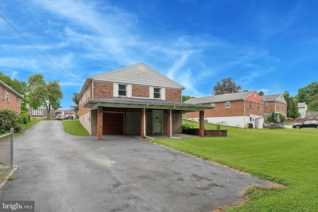 909 Rocklynn Rd, Springfield, PA 19064 - view of front facade featuring asphalt driveway, an attached garage, brick siding, a front yard, and a residential view