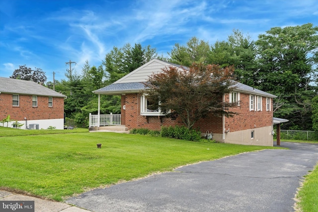 909 Rocklynn Rd, Springfield, PA 19064 - view of property exterior with a lawn and brick siding