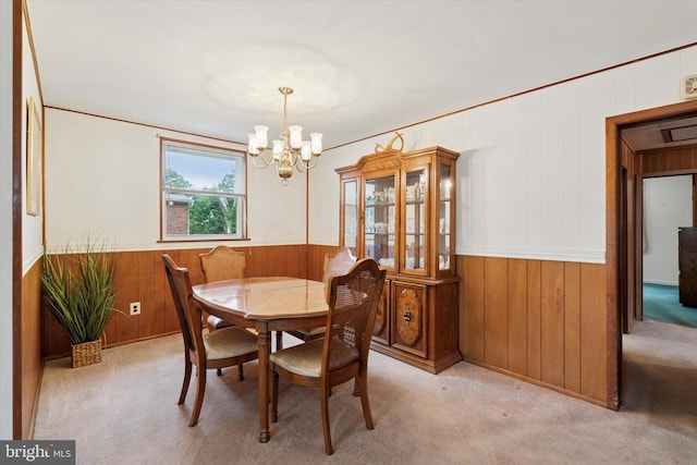 909 Rocklynn Rd, Springfield, PA 19064 - dining space featuring wood walls, a chandelier, carpet floors, and a wainscoted wall