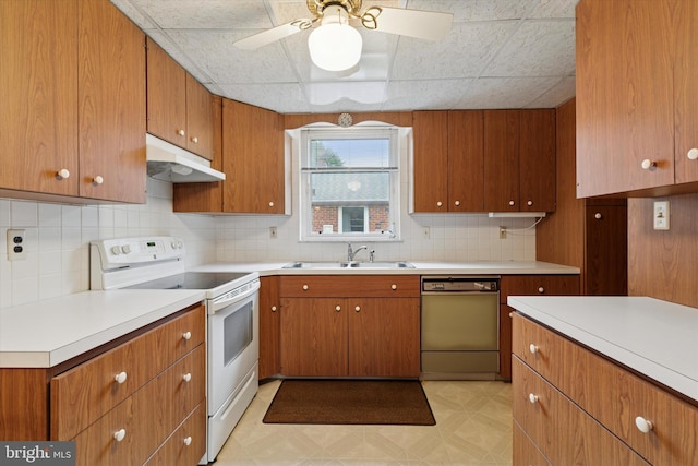 909 Rocklynn Rd, Springfield, PA 19064 - kitchen with dishwasher, white electric range, under cabinet range hood, tasteful backsplash, and light countertops