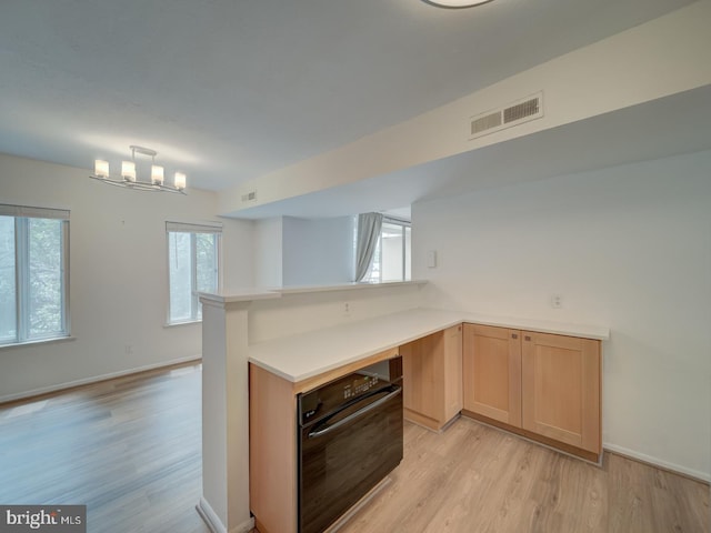5017 7th Rd S Unit 101, Arlington, VA 22204 - kitchen featuring oven, light wood-style floors, light countertops, and a peninsula