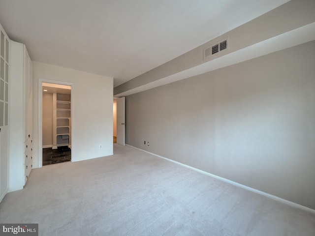 5017 7th Rd S Unit 101, Arlington, VA 22204 - unfurnished bedroom featuring carpet, a spacious closet, a closet, and baseboards