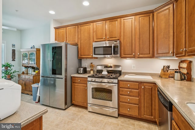 9 Brant Ct, Fredericksburg, VA 22406 - kitchen with stainless steel appliances, brown cabinetry, light countertops, and recessed lighting
