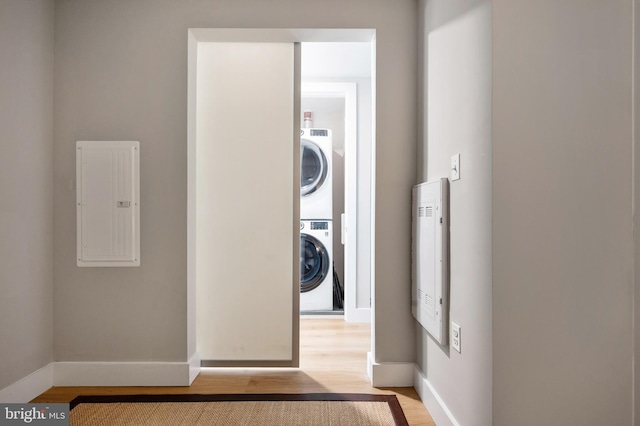 801 N Fairfax St Unit 314, Alexandria, VA 22314 - washroom featuring electric panel, estacked washer and dryer, light wood finished floors, and baseboards