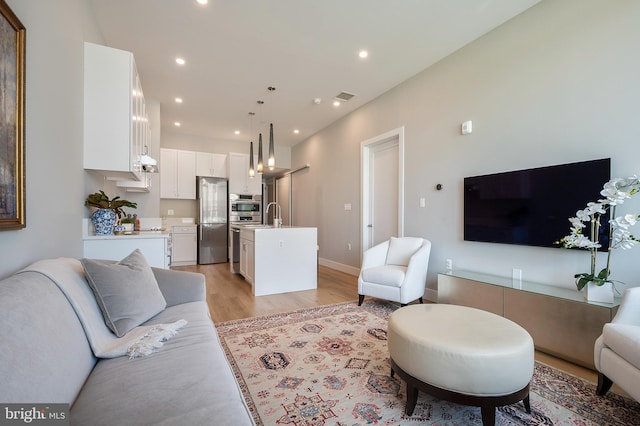 801 N Fairfax St Unit 314, Alexandria, VA 22314 - living room with light wood finished floors, recessed lighting, and baseboards