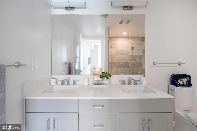 801 N Fairfax St Unit 314, Alexandria, VA 22314 - bathroom featuring double vanity, toilet, and a tile shower