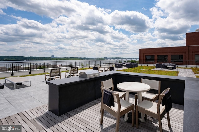 801 N Fairfax St Unit 314, Alexandria, VA 22314 - wooden terrace with area for grilling, a bar, a patio, and a water view