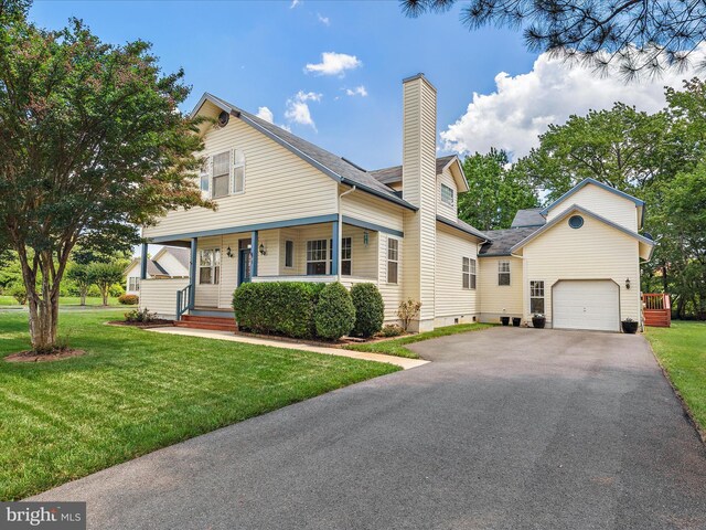 2 Assawoman Ave, Ocean View, DE 19970 - view of front facade with a chimney, a porch, a garage, and a front lawn