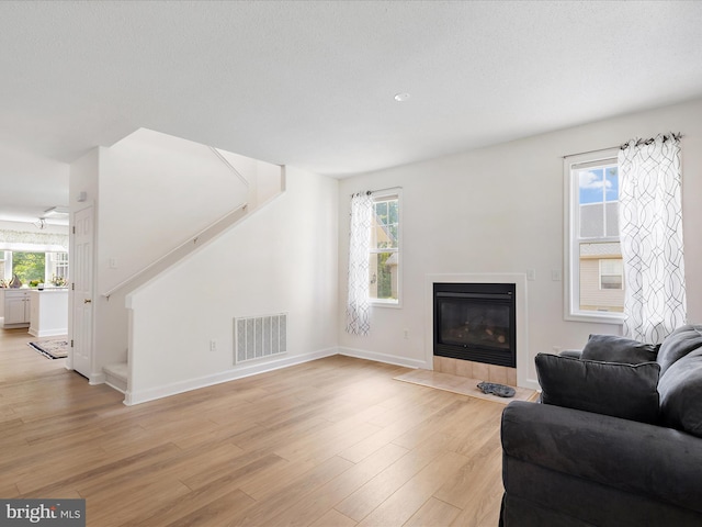2 Assawoman Ave, Ocean View, DE 19970 - living area with stairs, light wood finished floors, and a fireplace with flush hearth
