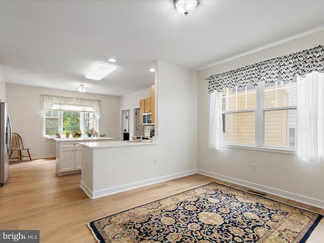 2 Assawoman Ave, Ocean View, DE 19970 - kitchen featuring appliances with stainless steel finishes, light wood finished floors, light countertops, a peninsula, and recessed lighting