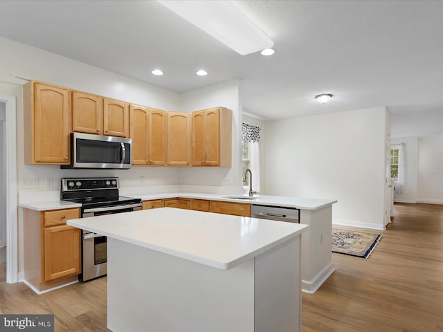 2 Assawoman Ave, Ocean View, DE 19970 - kitchen with appliances with stainless steel finishes, a peninsula, light wood-style floors, light countertops, and recessed lighting